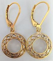 Front view of gold-tone silver earrings showing circular openwork design with pear-shaped diamonds around edges