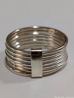 Top view of silver ring showing multiple parallel bands with a vertical rectangular accent.