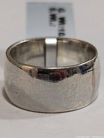 Front and exterior view of silver band ring showing width and finish