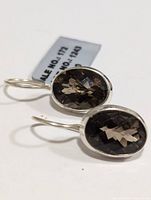 Pair of silver smokey quartz dangle earrings with oval faceted stones viewed from the front showing clarity and cut of stones.