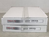 Stacked white rectangular cardboard boxes labeled 'Raybestos Professional Brake Parts 580503R Brake Rotor'