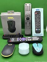 Photo of all mice and remote controls showing four mice including Onn gaming mouse with open box and four remote controls including Sony and Onn remotes.