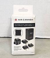 Photo of Air Canada dual wattage converter adapter plug kit packaging showing converter and plug adapters.