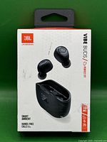 Front of retail box showing JBL logo, image of earbuds and charging case, product name 'Vibe Buds', and feature highlights such as smart ambient and hands-free calls.