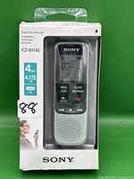 Front view of sealed Sony ICD-BX140 digital voice recorder in original packaging showing the device, display, and control buttons.