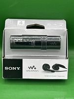 Front view of the Sony Walkman NWZ-B183F in original packaging showing the device and included earphones.