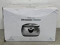 Box of Ukoke 3800S Ultrasonic Cleaner showing product image and model with signs of wear and damage.