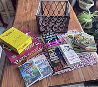 Photo of games, books, and plastic crate on table