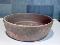 View of round handmade wooden bowl showing natural wood grain and smooth matte finish.