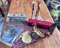 Overview of lot items showing all miscellaneous home decor pieces on a wooden table.