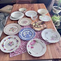 Top view of all plates and bowls on table showing various designs and floral patterns