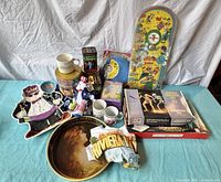 Overview of all vintage items on display including Batman bagatelle game, model kits, frisbee, ceramic mugs, and various toys.