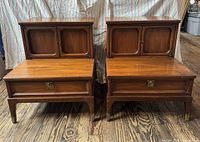 Front view of both end tables side by side on wood floor against backdrop