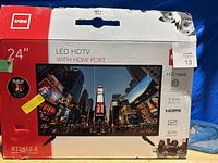 Box showing 24 inch RCA LED HDTV with HDMI port, model RT2412-E, HD ready, 60 Hz refresh rate.