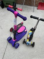 Photo showing front view of two scooters highlighting colors and design