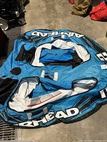 Top-down view of blue Air Head inflatable tube showing one rider area, handles, and branding.