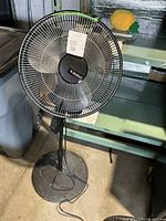 Front view of the Lasko pedestal fan showing blades and protective grille with Lasko logo at center