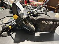 Mastercraft belt sander side angle showing dust collection bag and handle