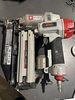 Porter Cable and JITOOL nailers shown side by side on a dark surface.