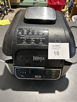 External view of the black Ninja air fryer grill showing top and front digital control panel.