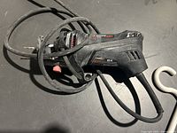 Side view of the RotoZip RotoSaw rotary tool showing model and branding with power cord wrapped around.