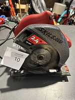 Full side view of Skilsaw corded circular saw showing red body, black branding, and blade diameter label.