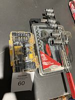 Photo showing the DeWalt yellow bit case with various socket bits, and RoadPro black plastic tray with several chrome sockets in various sizes