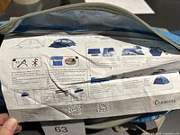 Close-up of the label on the main tent bag with setup graphics and instructions, showing the Commodus brand name.