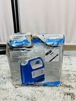 Damaged blue and white box of the 12V air compressor showing front and side with visible wear and tears