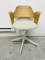 Front view of an adjustable conference chair with white stained oak veneer back and beige upholstered cushioned seat on a white 5-leg base.