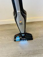 Front view showing Electrolux logo, LED lights on cleaning head and body design