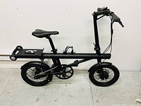 Left side profile of bike showing frame, wheels, folding mechanism