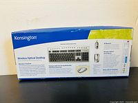 Side view of the packaging showing product features and images of keyboard, mouse, and USB receiver.
