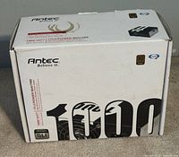 Closed box showing Antec TruePower Quattro 1000 watt power supply branding and certification labels (80 Plus Bronze) on white packaging.