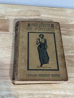 Front cover of the book showing title, author, and illustration on tan hardcover