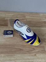 Front and top view of Chelsea Football Club shoe bank toy showing club badge, blue, white, and yellow colors.