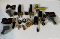 Top-down view of all 20 pieces in the Chemical Guys Torq Foam Cannon nozzle set showing brass fittings, black plastic handles, and connectors.