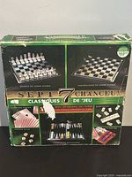 Box showing front graphics of the Lucky 7 Seven Gaming Classics set, including glass chess and checkers board images