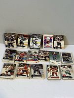 Closer view of hockey cards spread on a white surface showing detailed player images and team logos.