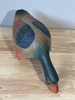 Front view of the vintage wooden duck carved in flying posture showing detailed painted feathers and colors.