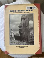 Photo of the front cover of the book showing the title, subtitle, author names and a black and white photograph of Thor Heyerdahl beside a Moai statue.
