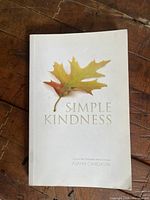 Front cover of the book titled Simple Kindness, featuring a leaf illustration and the author's name Ajahn Candasiri.