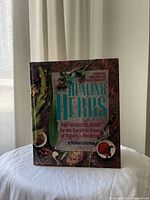 Front cover of the book 'The Healing Herbs' by Michael Castleman showing the title and herbal graphics.