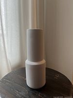 Photo of the lavender ceramic vase showing its tall, two-tier cylindrical shape and matte finish.