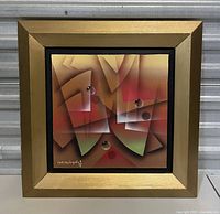 Photo of framed abstract geometric painting with artist's signature