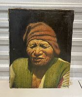 Full view of vintage oil painting showing native Latin American man with reddish-brown hat and green garment on dark background, signed by artist Larriega.