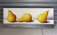 Full view of the rectangular canvas painting showing three yellow pears with shadows, signature on bottom right.