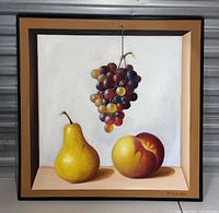 Full view of vintage painting showing a pear, peach, and grapes against a white background with a faux frame.
