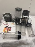 Full lot arranged showing all blender components, tumblers, lids, measuring cup, and recipe booklet