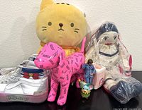 Full lot showing Sailor Moon silver high tops, yellow cat plush, pink dog plush, three figurines and vintage cloth Pierrot doll